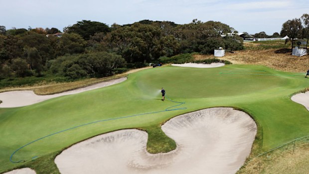 A member of the grounds crew waters the fourth green prior to the 2019 Presidents Cup at Royal Melbourne Golf Club 