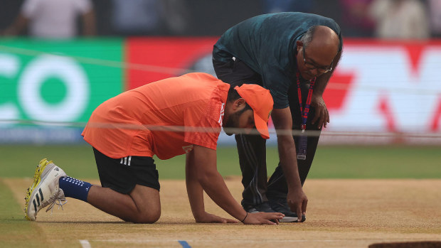 Indian captain Rohit Sharma inspects the pitch at Mumbai's Wankhede Stadium ahead of the World Cup semi-final against New Zealand