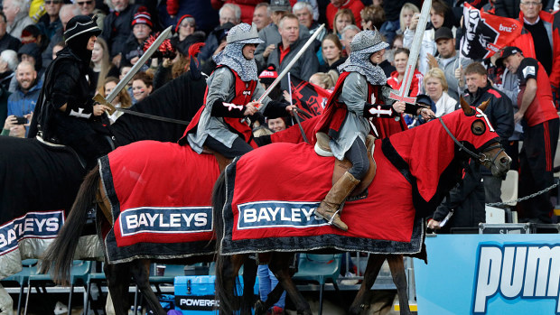 The Crusader horseman ride around the arena 