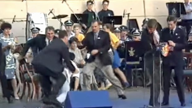 Ian Kiernan and others jump on  David Kang, who had menacingly rushed Prince Charles while firing two blank shots from a pistol. 