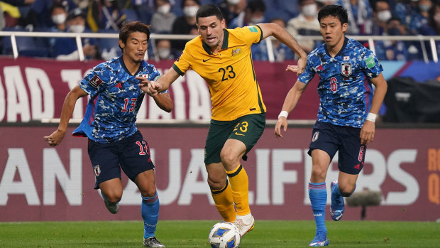 Tom Rogic of Australia competes for the ball against Hidemasa Morita and Wataru Endo of Japa