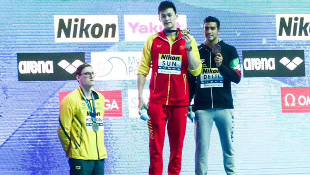 Mack Horton (left) protesting against Sun Yang (centre) at the 2019 World Swimming Championships.