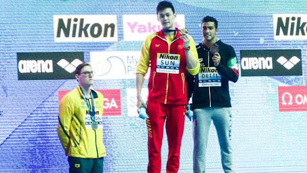 Mack Horton (left) protesting against Sun Yang (centre) at the 2019 World Swimming Championships.