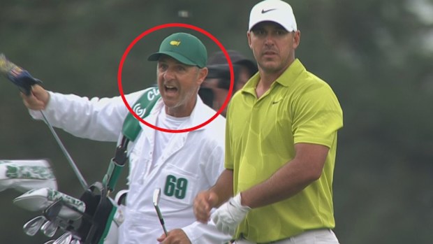 Brooks Koepka's caddie, Ricky Elliott, appears to offer advice to playing partner Gary Woodland.