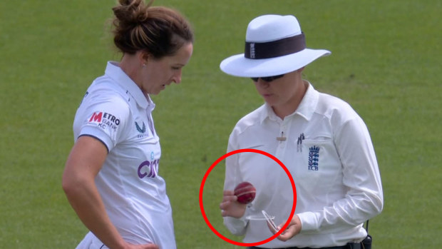 England fast bowler Kate Cross showing umpire Anna Harris the ball on day two of the Women's Ashes.