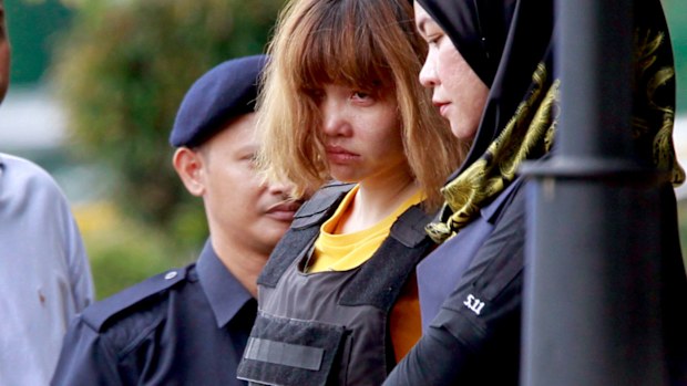 Vietnamese suspect Doan Thi Huong, second from right, is escorted by police officers out of court in Sepang. (AAP)