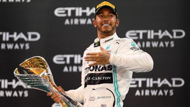 Race winner Lewis Hamilton of Great Britain and Mercedes GP celebrates on the podium