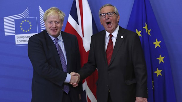 FILE - In this Thursday, Oct. 17, 2019 file photo British Prime Minister Boris Johnson shakes hands with European Commission President Jean-Claude Juncker during a press point at EU headquarters in Brussels. 