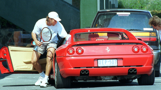 Pat Rafter getting out of the Injured Mark Philippoussis new Ferrari