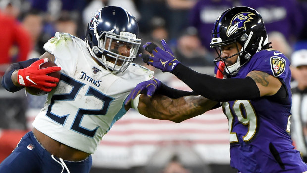 Derrick Henry #22 of the Tennessee Titans carries the ball against Earl Thomas #29 of the Baltimore Ravens 