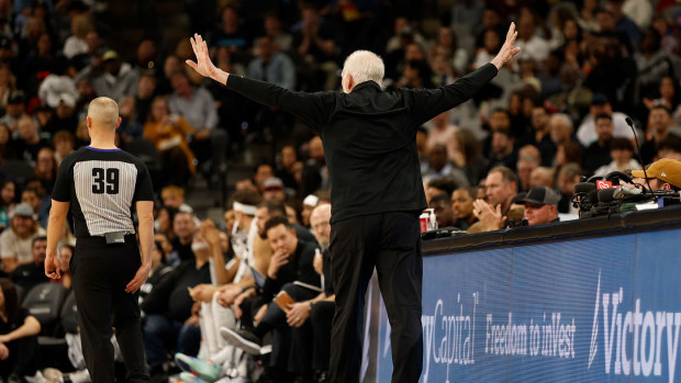Gregg Popovich gesturing for the crowd to be silent after they relentlessly booed Kawhi Leonard
