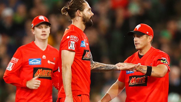Kane Richardson of the Renegades (2L) celebrates after dismissing Nic Maddinson of the Stars