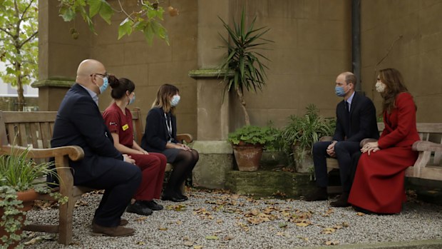 Prince William and his wife Kate the Duchess of Cambridge meet medical staff, from left, Head of Pharmacy Sotiris Antoniou, Respiratory Physio Isobel Fale and Medical Oncology Trainee and Chief Registrar Dr Myria Galazi, as they visit St. Bartholomew's Hospital in London, to mark the launch of the nationwide 'Hold Still' community photography project, Tuesday, Oct. 20, 2020