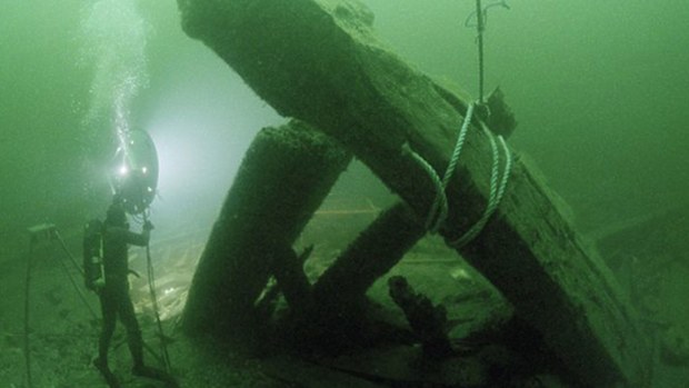 Timber from the Kronan warship is examined during a previous exploration. (National Geographic)