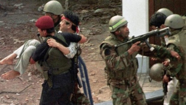 A hostage is carried out of the complex after the operation.