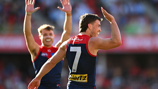 Jack Viney celebrates with teammates after kicking a goal during the round 23 AFL match between the Gold Coast Suns and the Melbourne Demons.