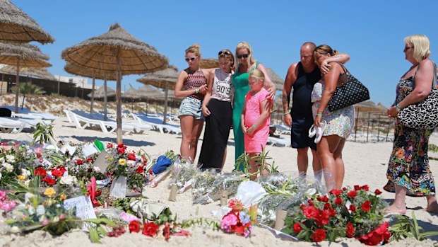 Mourners lay flowers in tribute to the 38 victims of the Tunisia resort gunman.