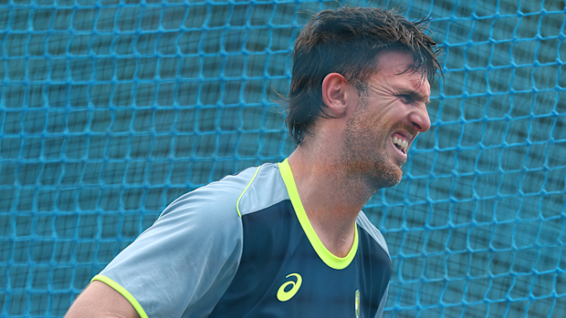 Mitchell Marsh reacts after being struck by the ball during a training session.