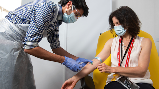 In this undated photo issued by the University of Oxford, a volunteer is administered the coronavirus vaccine developed by AstraZeneca and Oxford University, in Oxford, England. (University of Oxford/John Cairns via AP