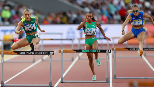 Sarah Carli (left) leaps over a hurdle at the 2023 World Athletics Championships in Budapest.