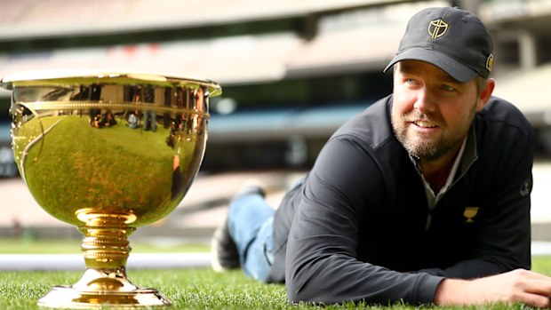 Marc Leishman cuts the grass on the MCG ahead of the 2019 Presidents Cup