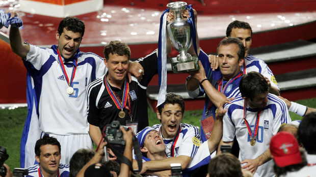 Otto Rehhagel hoists the Euro 2004 trophy with his Greek underdogs.