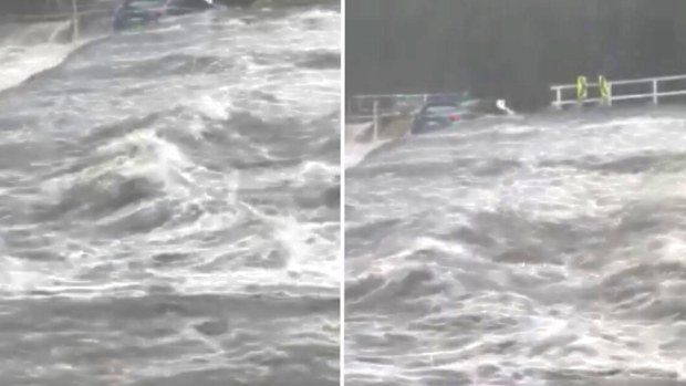 A car is swept off the weir in the Royal National Park during the severe thunderstorm in NSW.