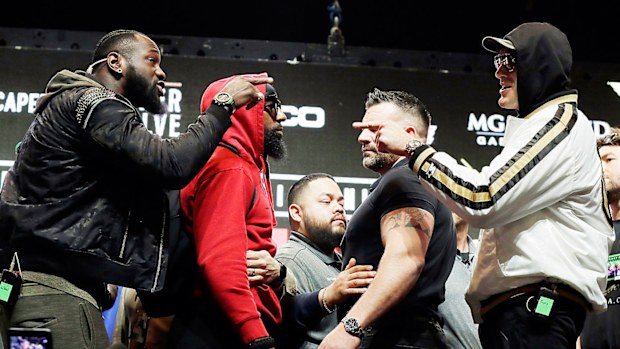 Deontay Wilder, left, and Tyson Fury, of England, right, face off for photographers 