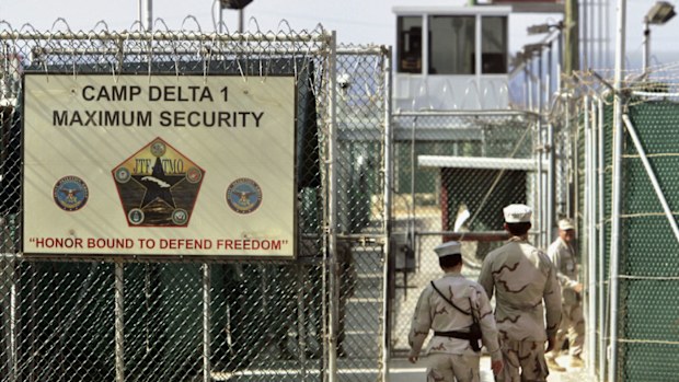 In this June 27, 2006, file photo, reviewed by a US Department of Defense official, US military guards walk within Camp Delta military-run prison, at the Guantanamo Bay US Naval Base, Cuba