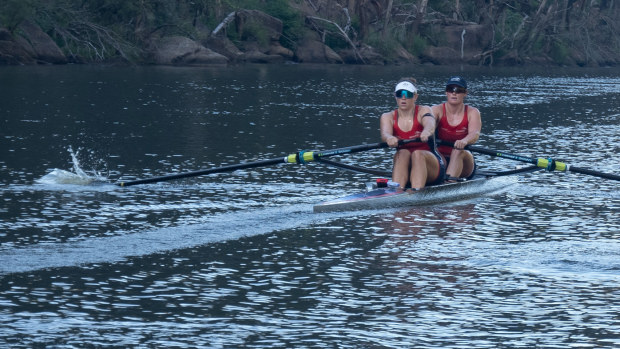 Paige Barr (front) and Bronwyn Cox training on the Nepean River.