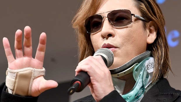 X Japan drummer Yoshiki appears in a neck brace after emergency surgery. (AFP)