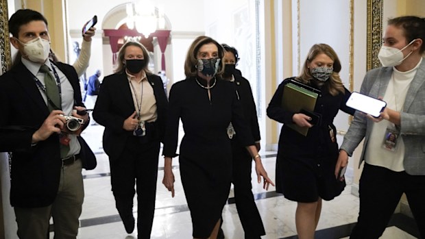 Speaker of the House Nancy Pelosi of Calif., arrives at the House chamber at the Capitol in Washington, Wednesday, Jan. 13, 2021, as the House of Representatives pursues an article of impeachment against President Donald Trump for his role in inciting an angry mob to storm the Capitol last week.