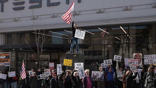 Protesters outside a Tesla dealership earlier this month.