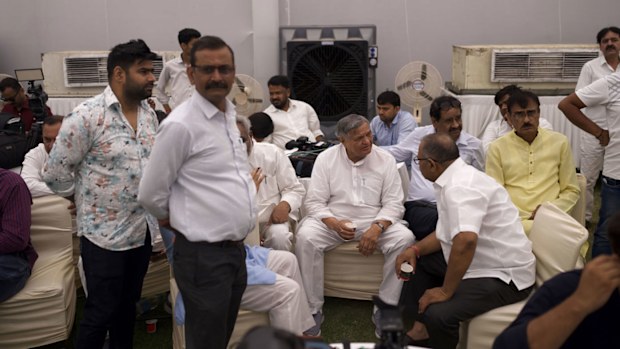India election 2024 - People rest in front of water coolers and fans set up inside a tent at the Congress party headquarters in New Delhi, India.