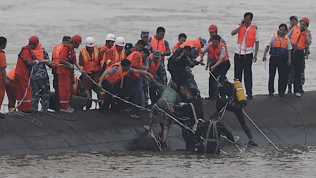 Rescuers pull a survivor to safety. (AAP)