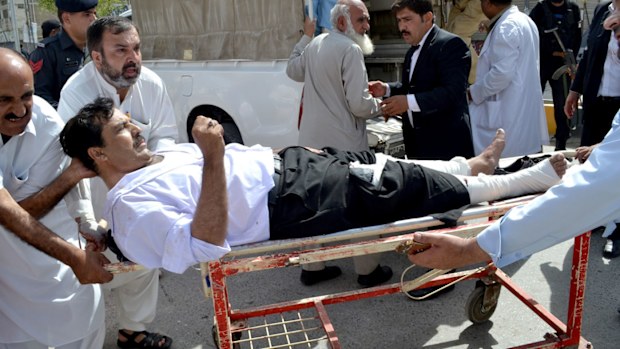 People carry an injured lawyer to a hospital following a bomb blast in Quetta, Pakistan. (AAP)