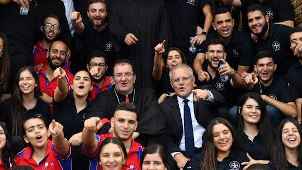 Prime Minister Scott Morrison and Bishop Antoine-Charbel Tarabay with young parishoners after Good Friday Easter services at St Charbel's Catholic Maronite Church at Punchbowl.