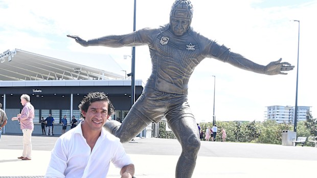 Johnathan Thurston poses with his statue during the unveiling of the Jonathan Thurston bronze statue at the Queensland Country Bank Stadium 