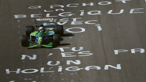 Michael Schumacher's Jordan teammate, Andrea de Cesaris, drives over graffiti on the track protesting over Bertrand Gachot's treatment.