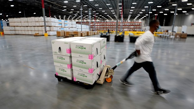 Boxes containing the Moderna COVID-19 vaccine are moved to the loading dock for shipping at the McKesson distribution centre in Olive Branch, Mississippi.