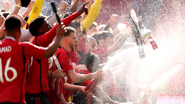 Mason Mount of Manchester United sprays champagne as they celebrate victory during the Emirates FA Cup Final match between Manchester City and Manchester United at Wembley Stadium on May 25, 2024 in London, England. (Photo by Alex Pantling/Getty Images)