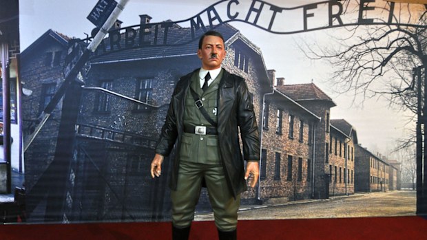 A wax figure of Adolf Hitler is displayed against the backdrop of an image of Auschwitz-Birkenau complex of concentration camps, at De Mata Museum in Yogyakarta, Indonesia.  (AP Photo/Slamet Riyadi)