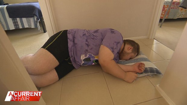 Conor lying on the tiled floor.