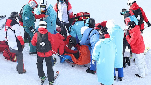 Rina Yoshika of Team Japan receives medical attention after crashing during the Snowboard Slopestyle Training session