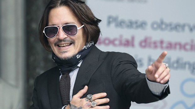 Actor Johnny Depp gestures as he arrives at the High Court to give evidence in his libel case, in London, Wednesday July 15, 2020. 