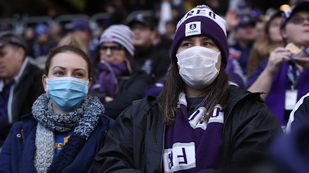Spectators look on wearing face masks during the round 7 AFL match between the Fremantle Dockers and the West Coast Eagles at Optus Stadium on July 19, 2020 in Perth, Australia. (Photo by Paul Kane/Getty Images)