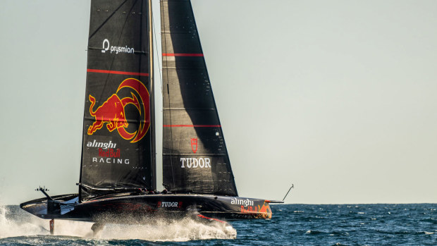 The Alinghi Red Bull Racing AC75 sails pass the Barcelona skyline during a training session on February 29, 2024 in Barcelona, Spain. 