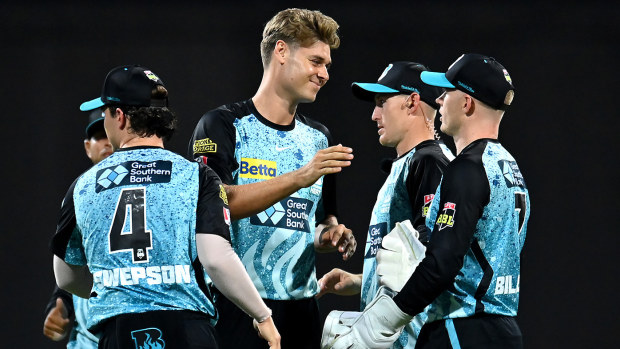 Spencer Johnson of the Heat celebrates with team mates after dismissing Liam Dawson of the Stars during the BBL match between Brisbane Heat and Melbourne Stars at The Gabba, on December 07, 2023, in Brisbane, Australia. (Photo by Albert Perez/Getty Images)