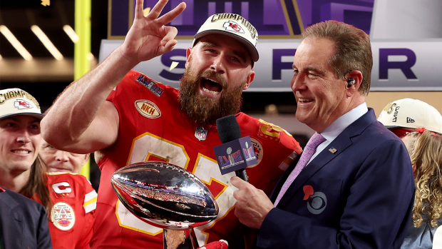 Travis Kelce of the Kansas City Chiefs holds up the number three after defeating the San Francisco 49ers to secure the franchise's second consecutive Super Bowl championship.
