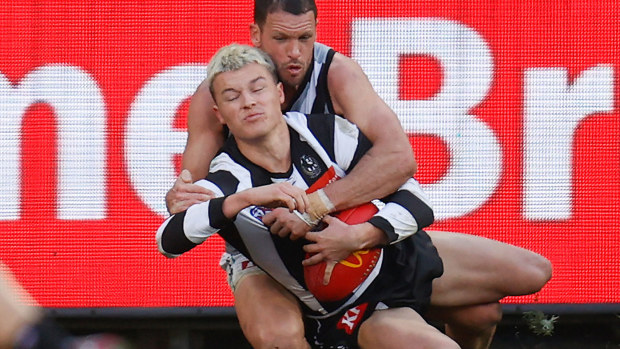 Collingwood youngster Jack Ginnivan tackled by Port Adelaide's Travis Boak